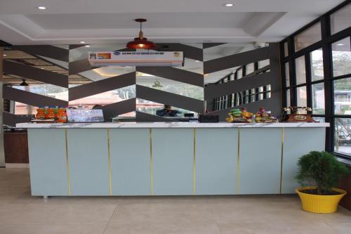 a lobby with a counter in a building at Hotel Grand Nitara in Kotdwāra