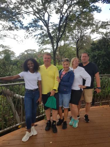 a group of people posing for a picture on a bridge at Teresita Home in Nairobi