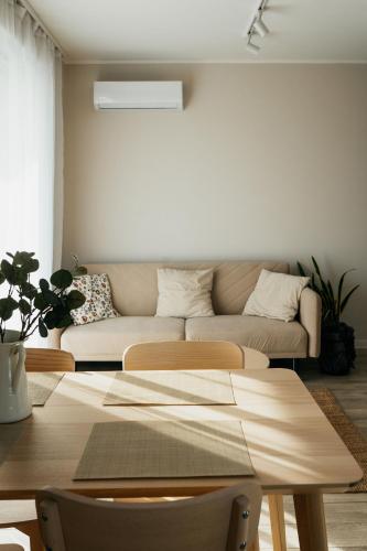 a living room with a couch and a table at Apartament ACTIV jezioro góry in Żywiec