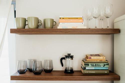 a wooden shelf with glasses and books on it at Apartament ACTIV jezioro góry in Żywiec