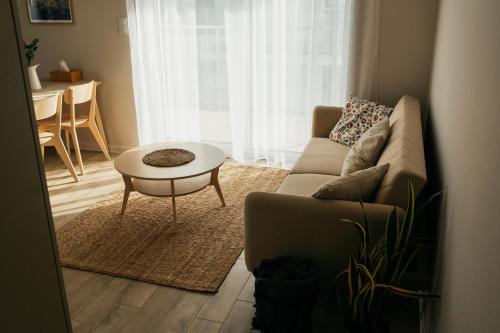 a living room with a couch and a table at Apartament ACTIV jezioro góry in Żywiec