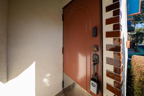 an entrance to a building with an orange door at Grand Hotel Narita Airport in Akaike