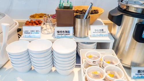 a bunch of plates on a table with food at Toyoko Inn Gotemba Ekimae in Gotemba