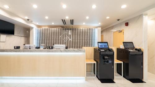 an office with a counter with two atm machines at Toyoko Inn Gotemba Ekimae in Gotemba