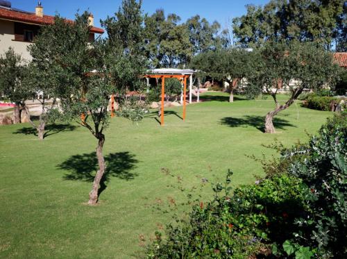 a park with an orange playground in the grass at Agriturismo S'Ispiga in Cuglieri