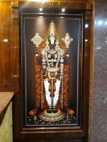 a framed picture of a skeleton in a wooden frame at HOTEL KSR GRANDs in Srikalahasti