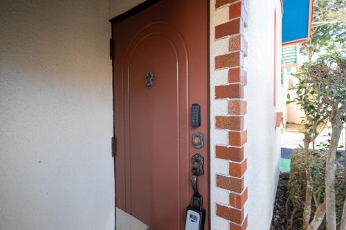 a door to a house with a guitar next to it at Grand Hotel Narita Airport in Akaike
