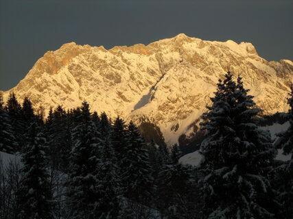 a snow covered mountain with trees in front of it at Ferienwohnung Klappacher in Maria Alm am Steinernen Meer