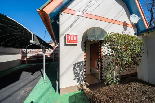 a house with a sign that reads at Grand Hotel Narita Airport in Akaike