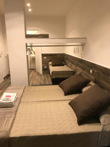 two beds in a room with two mattresses at MagloInnFiera in Bologna
