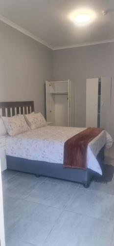 a bedroom with a large bed in a room at Abay Lodge in Durban
