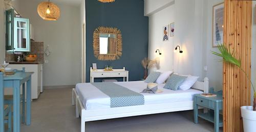 a bedroom with a bed and a table and a mirror at Kurmulis Studios in Stalos