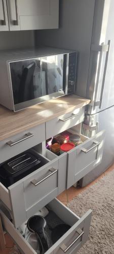 a kitchen with a counter with a microwave at Sweet Home in Wermelskirchen