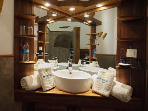 a bathroom with a sink and a large mirror at Antsanitia Resort in Mahajanga