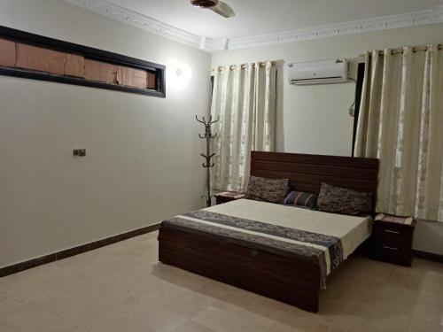 a bedroom with a bed in a room at 3-Beds with Terrace & Amenities in Karachi