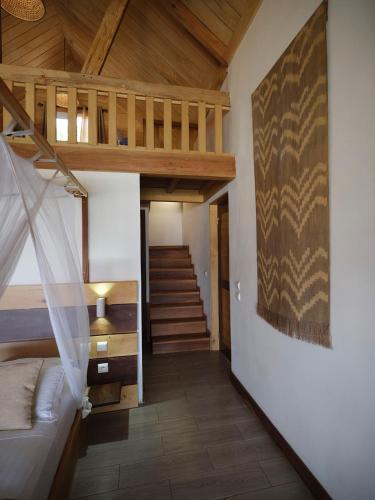a living room with a staircase and a stair case at Antsanitia Resort in Mahajanga