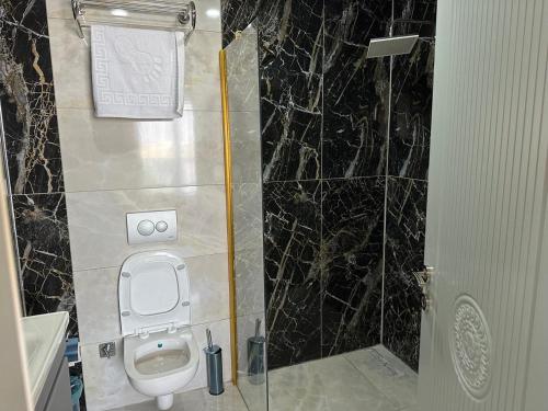 a bathroom with a toilet and a shower at world say hotel in Bostaniçi