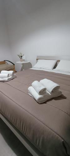 a bed with two folded towels on top of it at B&B Ristel in Lizzano