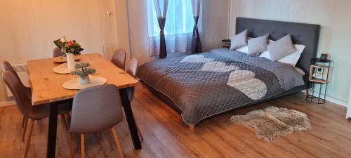 1 dormitorio con cama, mesa y comedor en Tiny House Valea Avrigului en Avrig