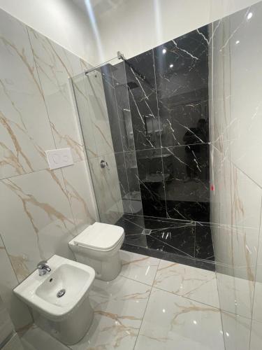 a bathroom with a toilet and a shower and a sink at Life Hotel in Casalnuovo di Napoli