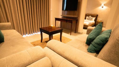 a living room with a couch and a piano at My Hotel by Trend in Aqaba