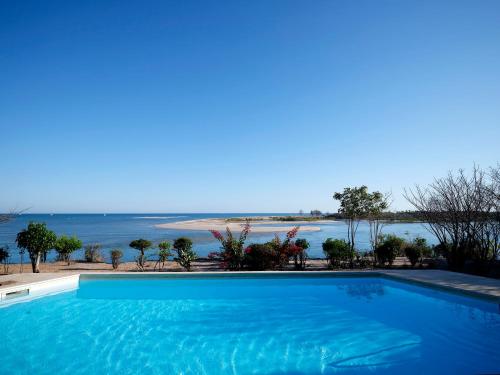 a swimming pool with a view of the ocean at Antsanitia Resort in Mahajanga