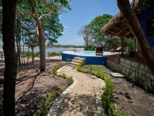 a path leading to a swimming pool in a resort at Antsanitia Resort in Mahajanga