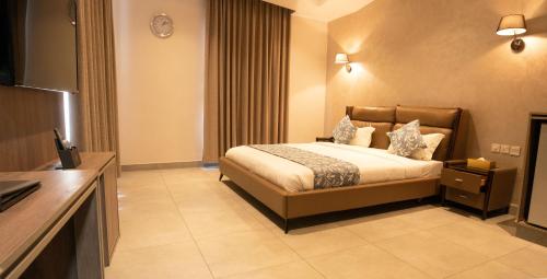 a hotel room with a bed and a television at My Hotel by Trend in Aqaba