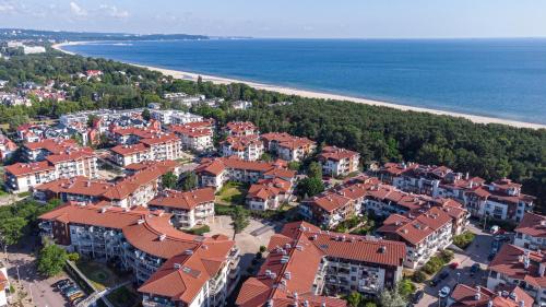 an aerial view of a town with houses and a beach at Kings Court - Neptun Park in Gdańsk