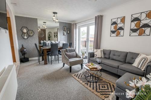 a living room with a couch and a table at The Catalina Breeze by Grandeur Property in Poole