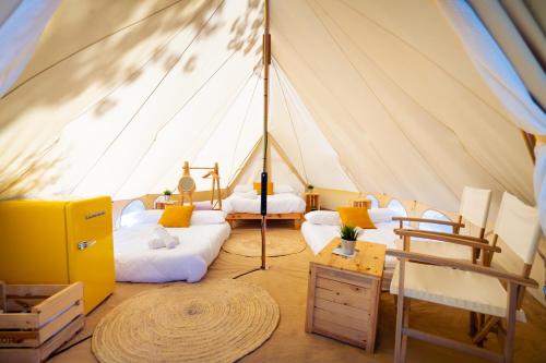 a room with two beds in a tent at Kampaoh Río Miño in A Guarda