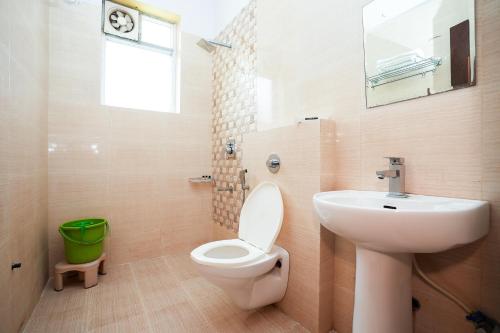 a bathroom with a white toilet and a sink at Agariya Haveli near Pichola Lake, Udaipur in Udaipur