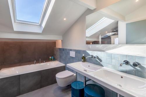 a bathroom with a sink and a toilet and a mirror at La Senpere - Maison à 20min de Saint Jean de Luz in Saint-Pée-sur-Nivelle