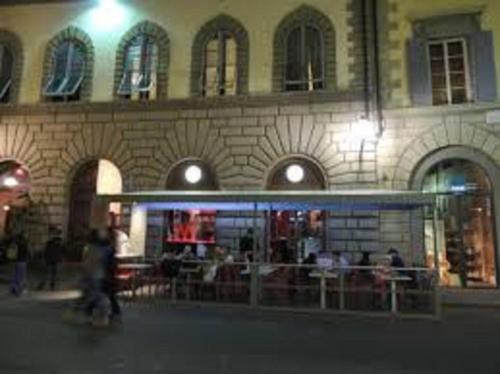 a group of people walking in front of a building at Palazzo dei Ciompi Suites in Florence