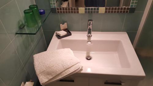 a bathroom sink with a towel and a faucet at SB Bed & Breakfast in Seborga