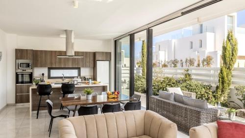 an open kitchen and living room with a table and chairs at Diamond villas in Protaras