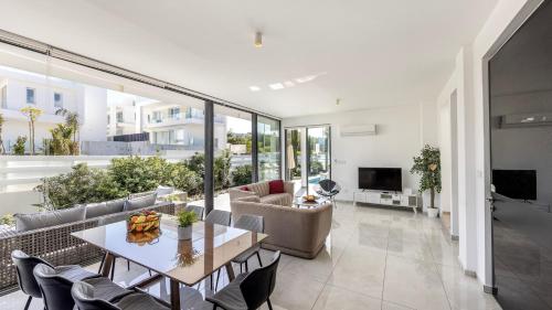 a living room with a table and a couch at Diamond villas in Protaras