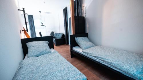 two beds in a room with blue pillows at Monteurwohnung in Freren Lingen in Freren