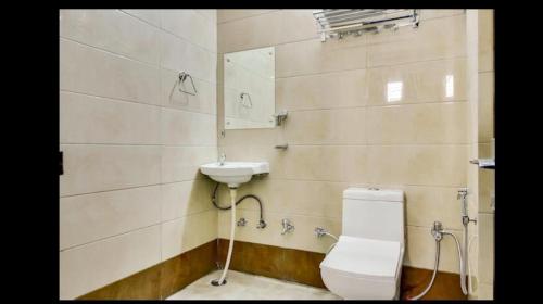a bathroom with a toilet and a sink at Peaceful Stay in New Delhi