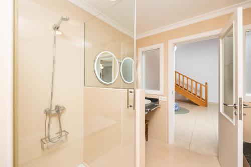 a bathroom with a shower with a glass door at Villa Saona in Playa Blanca