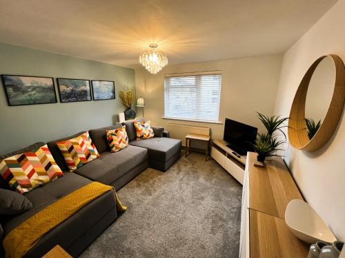 a living room with a couch and a television at Hope Cottage in Shanklin