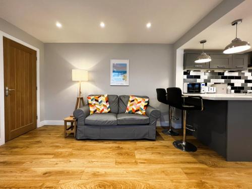 a living room with a couch and a table at Hope Cottage in Shanklin
