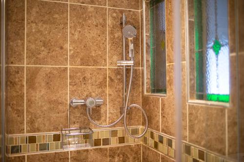 a shower with a shower head in a bathroom at Lavington Johnston in Johnston