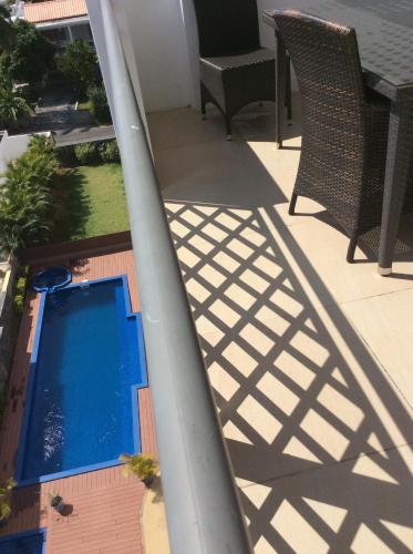 an overhead view of a swimming pool on a balcony at Fortuna Beach in Flic-en-Flac