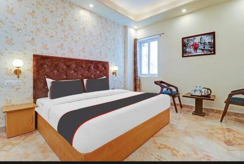 a bedroom with a large bed in a room at Willow Wood in Dehradun
