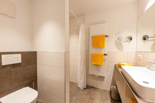 a bathroom with a toilet sink and a shower at Seehaus Winkler in Weissensee