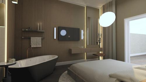 een badkamer met een bad en een bed en een tv bij Bridge Steet Apartments in Morpeth