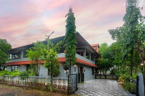 a house with a fence in front of it at EKO STAY- Brickstone Villa in Igatpuri