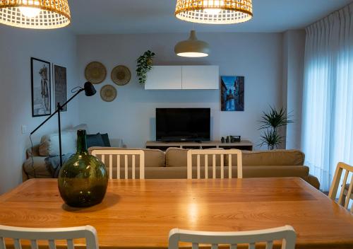 a living room with a wooden table and a couch at Casa Manolo in Luanco
