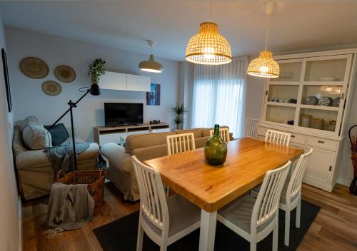 a living room with a wooden table and chairs at Casa Manolo in Luanco